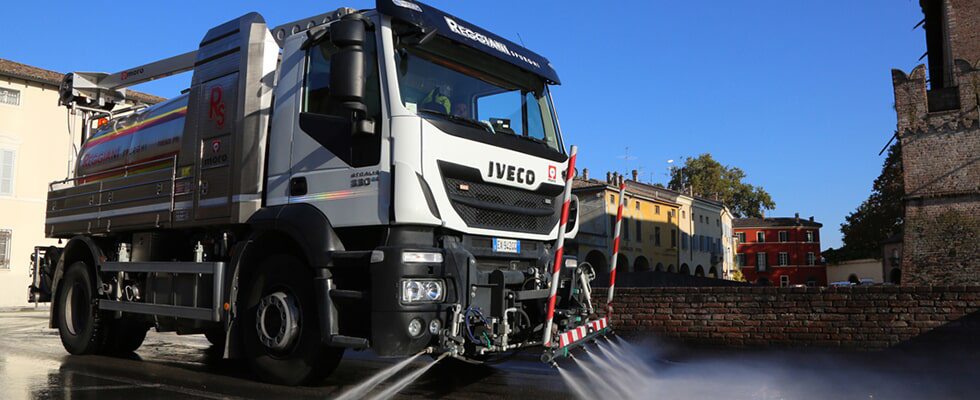 Una foto di un camion mentre lava una strada